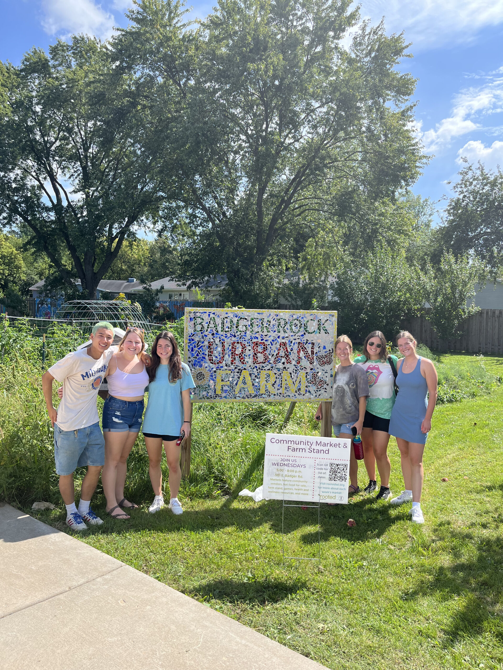 students in front of Badger Rock Community Garden sign
